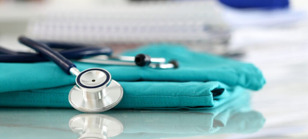 Stethoscope on top of a pair of scrubs