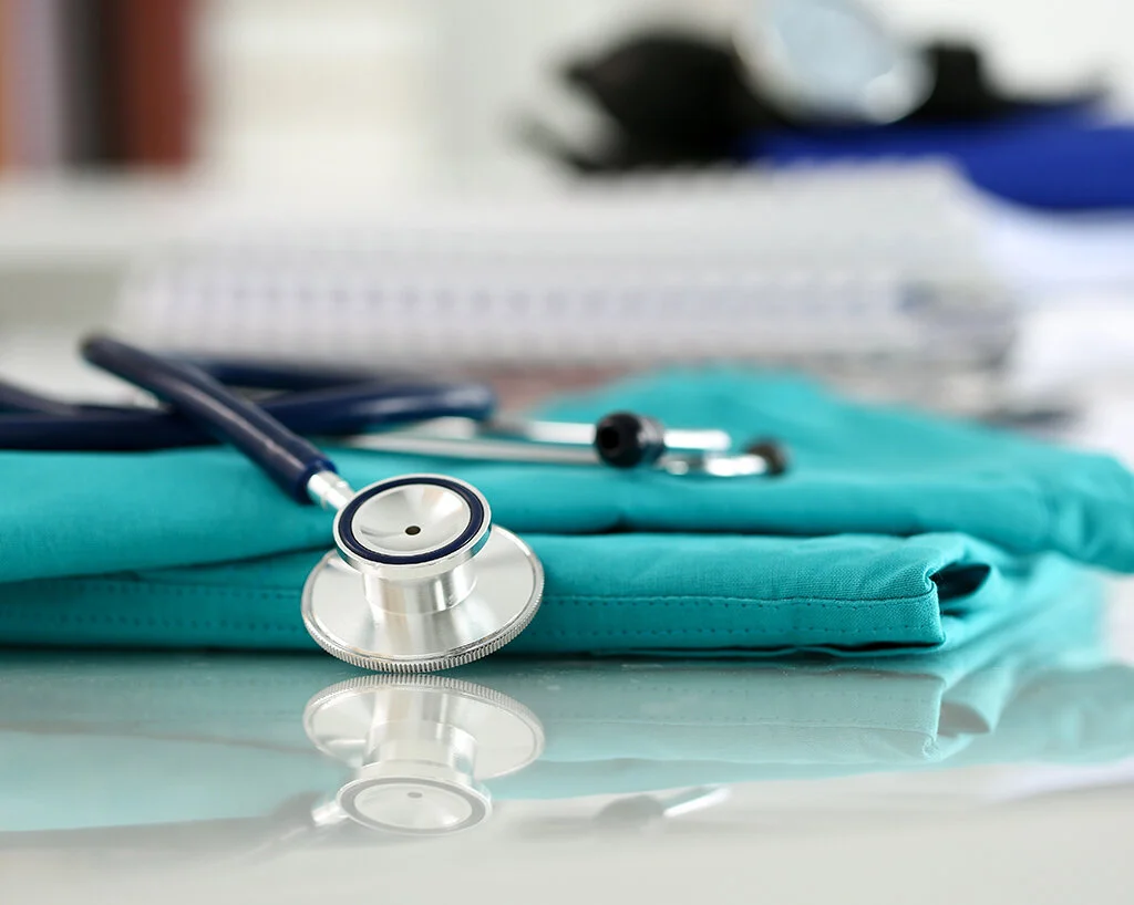 Stethoscope on top of a pair of scrubs