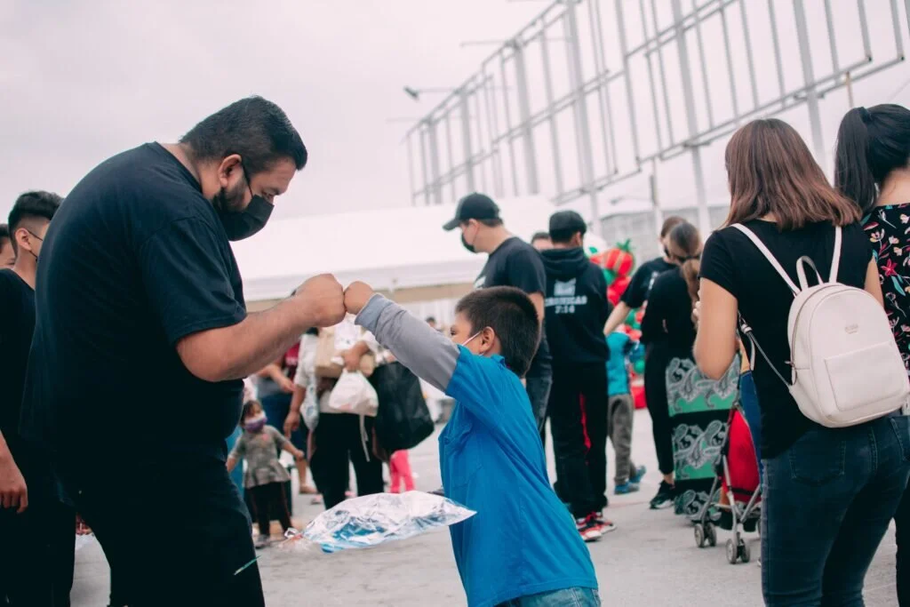 A child and man fist bump