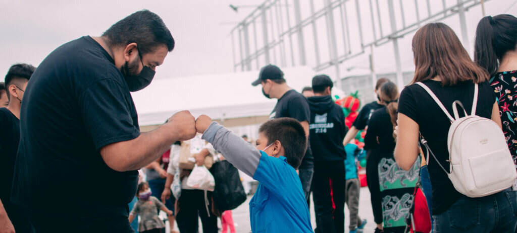 A child and man fist bump