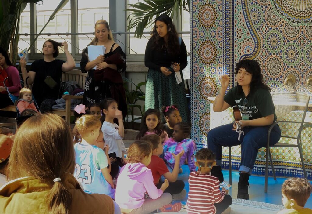 Children and adults interact at Garfield Park Conservatory
