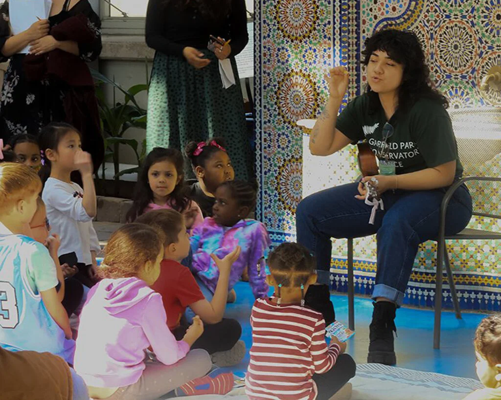 Children and adults interact at Garfield Park Conservatory