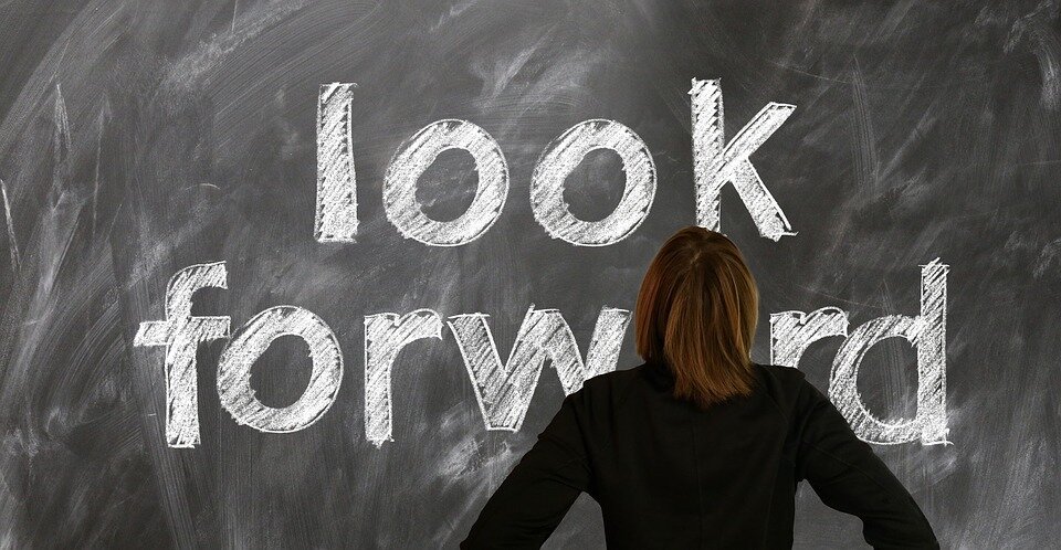 Person reading a blackboard that says “look forward”