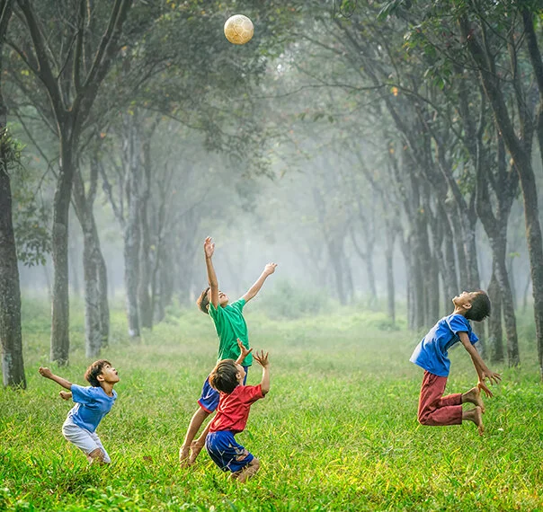 Four boys playing with a soccer ball