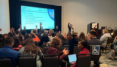 a crowd of people interacting during a conference