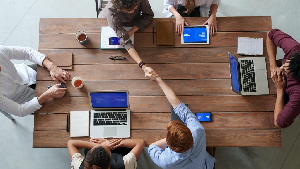 People around a table on their computers